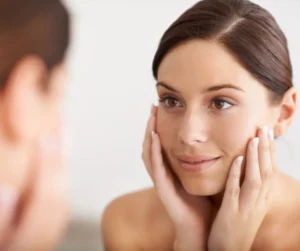 woman looking at a mirror, clear face skin
